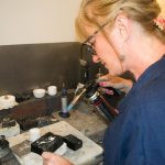 Sandra Kerns working in her studio with a blowtorch